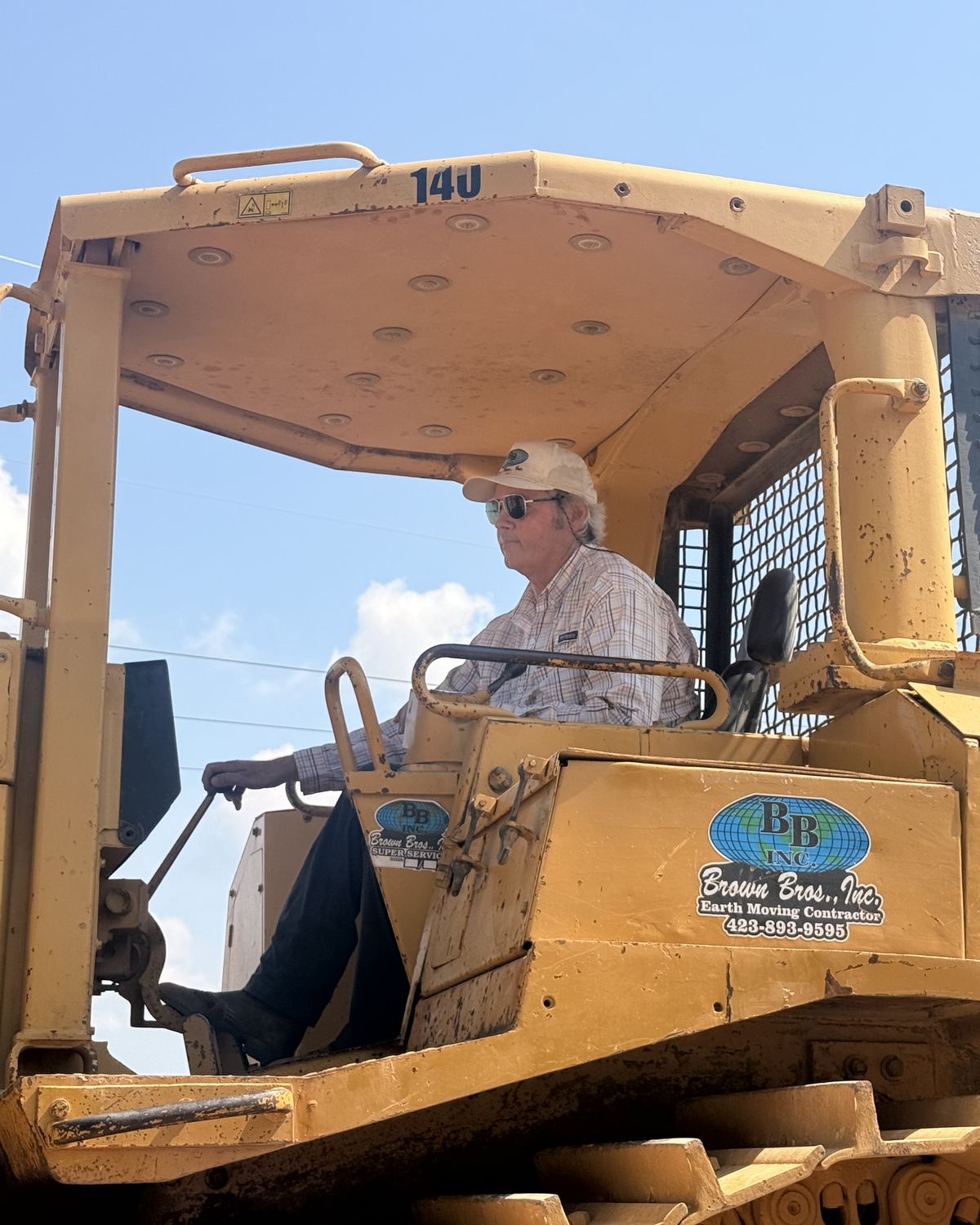 Tripp Brown, Co-Founder of Brown Bros., Inc., in the cab of a Cat D8N dozer